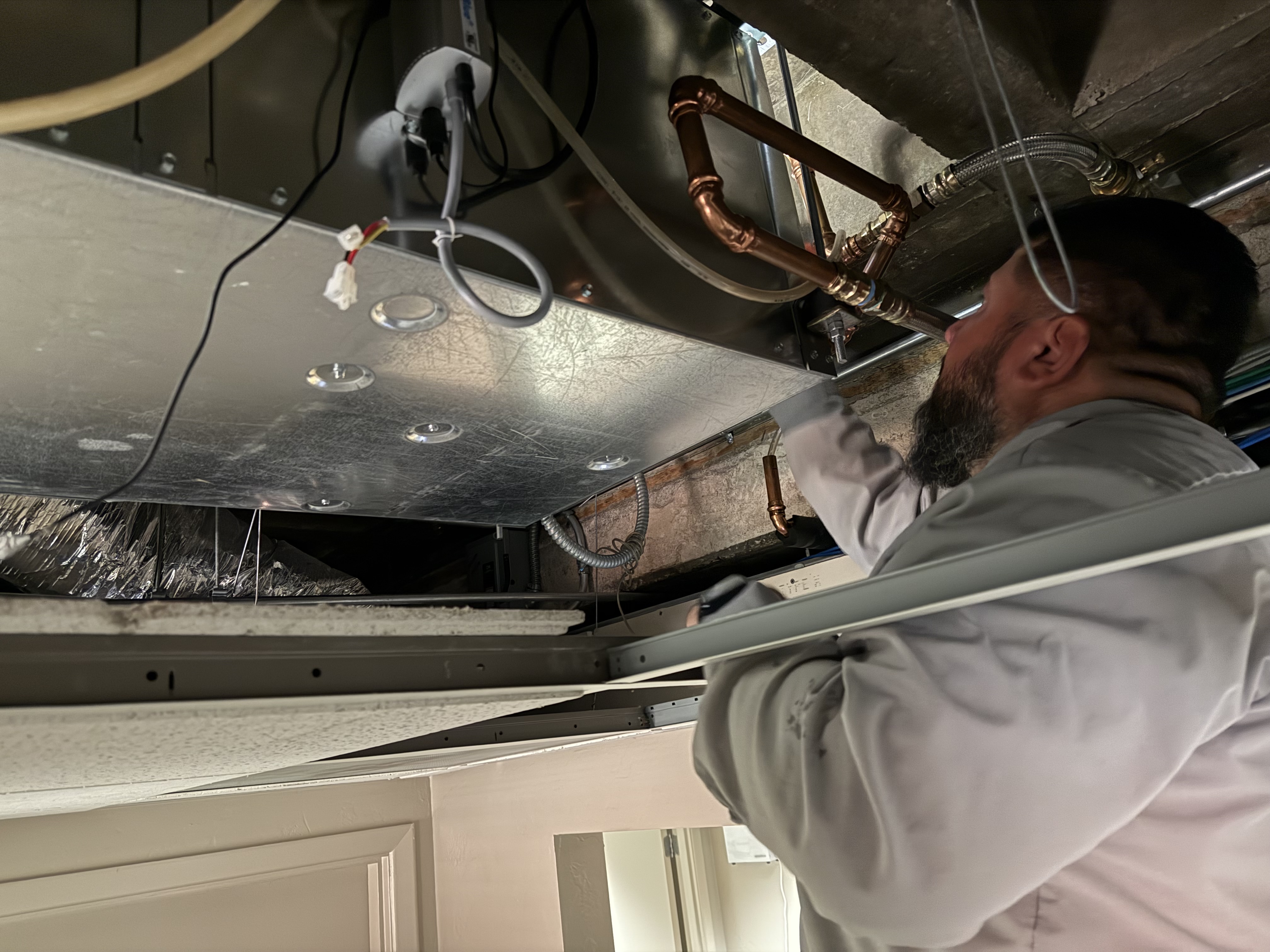 Technician working on rooftop unit