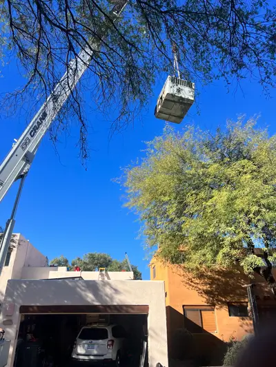 Portfolio image of SEER HVAC work done with a crane lift that is replacing an AC unit over a commercial building located in Phoenix, Arizona.